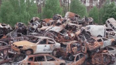 This stock video shows a dump of shot and burned cars in Irpin, Bucha district in 8K resolution
