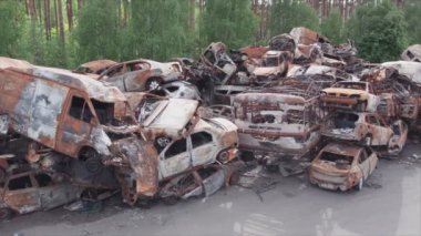 This stock video shows a dump of shot and burned cars in Irpin, Bucha district in 8K resolution