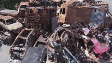 This stock video shows a dump of shot and burned cars in Irpin, Bucha district in 8K resolution