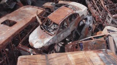 This stock video shows a dump of shot and burned cars in Irpin, Bucha district in 8K resolution