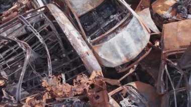This stock video shows a dump of shot and burned cars in Irpin, Bucha district in 8K resolution