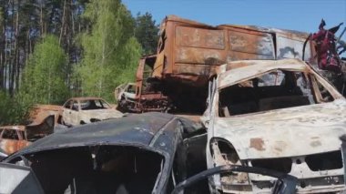 This stock video shows a dump of shot and burned cars in Irpin, Bucha district in 8K resolution