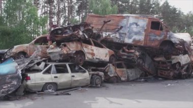 This stock video shows a dump of shot and burned cars in Irpin, Bucha district in 8K resolution