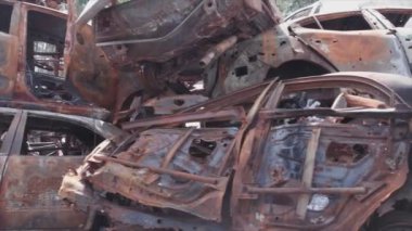 This stock video shows a dump of shot and burned cars in Irpin, Bucha district in 8K resolution