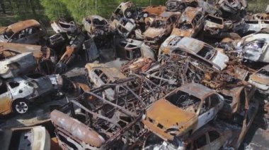 This stock video shows a dump of shot and burned cars in Irpin, Bucha district in 8K resolution