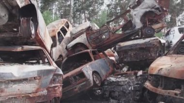 This stock video shows a dump of shot and burned cars in Irpin, Bucha district in 8K resolution