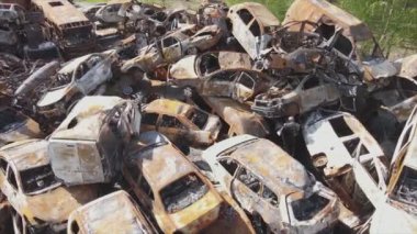 This stock video shows a dump of shot and burned cars in Irpin, Bucha district in 8K resolution