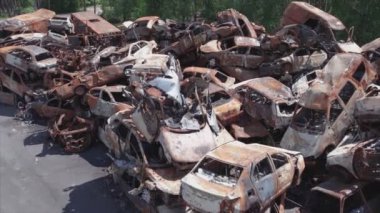 This stock video shows a dump of shot and burned cars in Irpin, Bucha district in 8K resolution