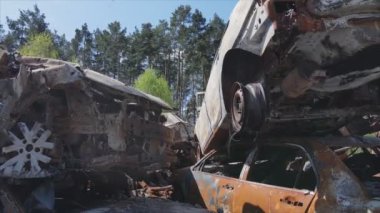 This stock video shows a dump of shot and burned cars in Irpin, Bucha district in 8K resolution