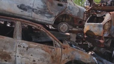 This stock video shows a dump of shot and burned cars in Irpin, Bucha district in 8K resolution