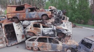 This stock video shows a dump of shot and burned cars in Irpin, Bucha district in 8K resolution