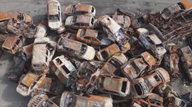 This stock video shows a dump of shot and burned cars in Irpin, Bucha district in 8K resolution