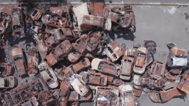 This stock video shows a dump of shot and burned cars in Irpin, Bucha district in 8K resolution