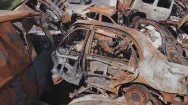 This stock video shows a dump of shot and burned cars in Irpin, Bucha district in 8K resolution