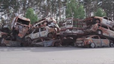 This stock video shows a dump of shot and burned cars in Irpin, Bucha district in 8K resolution