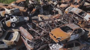 This stock video shows a dump of shot and burned cars in Irpin, Bucha district in 8K resolution