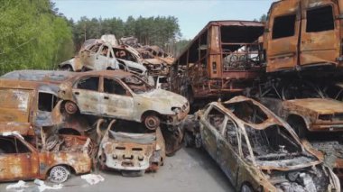 This stock video shows a dump of shot and burned cars in Irpin, Bucha district in 8K resolution