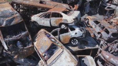 This stock video shows a dump of shot and burned cars in Irpin, Bucha district in 8K resolution