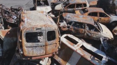 This stock video shows a dump of shot and burned cars in Irpin, Bucha district in 8K resolution