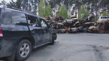 This stock video shows a dump of shot and burned cars in Irpin, Bucha district in 8K resolution