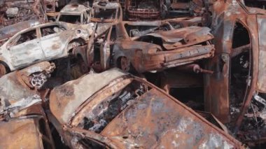 This stock video shows a dump of shot and burned cars in Irpin, Bucha district in 8K resolution