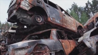 This stock video shows a dump of shot and burned cars in Irpin, Bucha district in 8K resolution