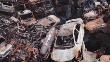 This stock video shows a dump of shot and burned cars in Irpin, Bucha district in 8K resolution