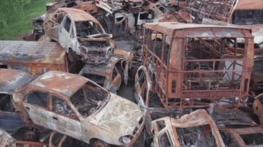 This stock video shows a dump of shot and burned cars in Irpin, Bucha district in 8K resolution
