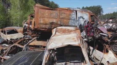 This stock video shows a dump of shot and burned cars in Irpin, Bucha district in 8K resolution