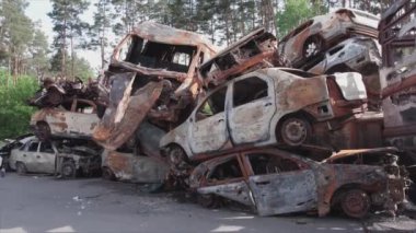 This stock video shows a dump of shot and burned cars in Irpin, Bucha district in 8K resolution