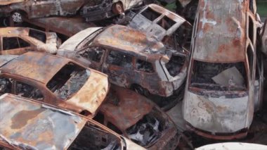 This stock video shows a dump of shot and burned cars in Irpin, Bucha district in 8K resolution