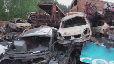 This stock video shows a dump of shot and burned cars in Irpin, Bucha district in 8K resolution