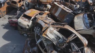 This stock video shows a dump of shot and burned cars in Irpin, Bucha district in 8K resolution