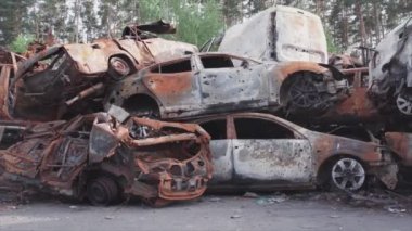 This stock video shows a dump of shot and burned cars in Irpin, Bucha district in 8K resolution