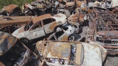 This stock video shows a dump of shot and burned cars in Irpin, Bucha district in 8K resolution