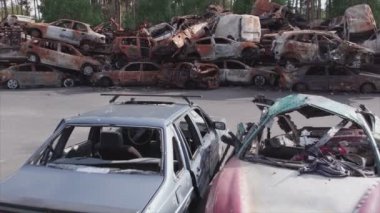 This stock video shows a dump of shot and burned cars in Irpin, Bucha district in 8K resolution