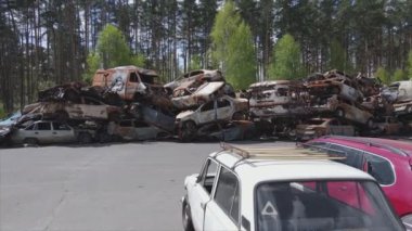 This stock video shows a dump of shot and burned cars in Irpin, Bucha district in 8K resolution