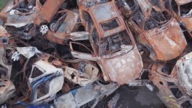 This stock video shows a dump of shot and burned cars in Irpin, Bucha district in 8K resolution