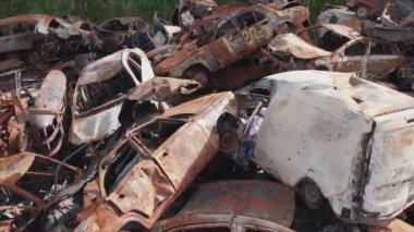 This stock video shows a dump of shot and burned cars in Irpin, Bucha district in 8K resolution