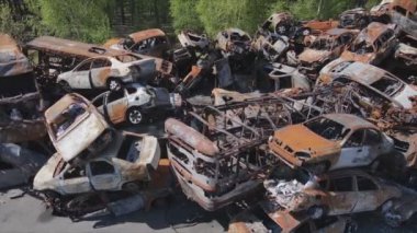 This stock video shows a dump of shot and burned cars in Irpin, Bucha district in 8K resolution