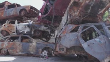 This stock video shows a dump of shot and burned cars in Irpin, Bucha district in 8K resolution