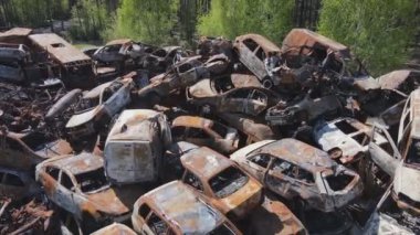 This stock video shows a dump of shot and burned cars in Irpin, Bucha district in 8K resolution