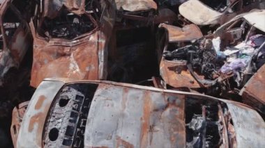 This stock video shows a dump of shot and burned cars in Irpin, Bucha district in 8K resolution