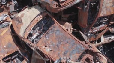 This stock video shows a dump of shot and burned cars in Irpin, Bucha district in 8K resolution