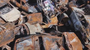 This stock video shows a dump of shot and burned cars in Irpin, Bucha district in 8K resolution