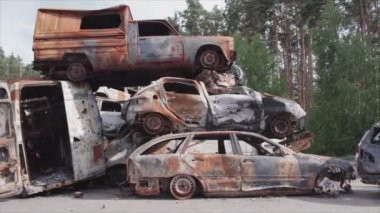 This stock video shows a dump of shot and burned cars in Irpin, Bucha district in 8K resolution