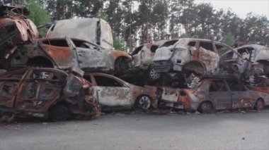 This stock video shows a dump of shot and burned cars in Irpin, Bucha district in 8K resolution