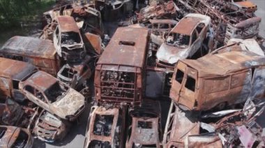 This stock video shows a dump of shot and burned cars in Irpin, Bucha district in 8K resolution