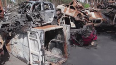 This stock video shows a dump of shot and burned cars in Irpin, Bucha district in 8K resolution