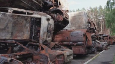 This stock video shows a dump of shot and burned cars in Irpin, Bucha district in 8K resolution